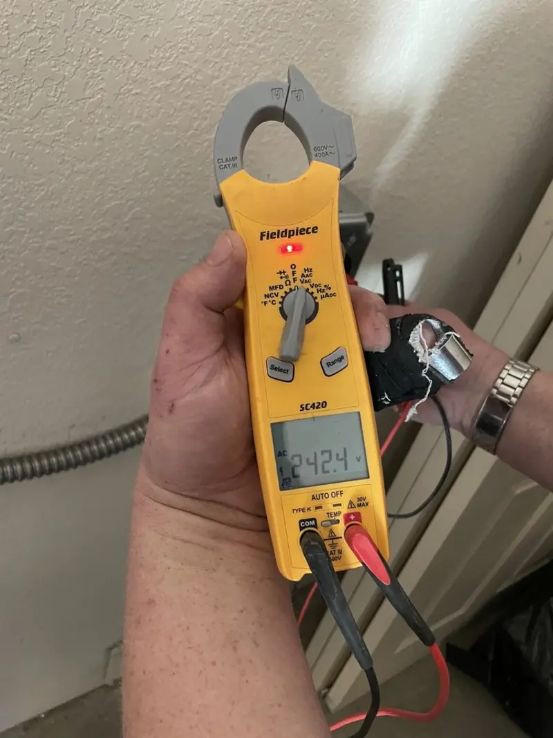 Voltage testing with clamp meter during Whole House Surge Protector in Providence